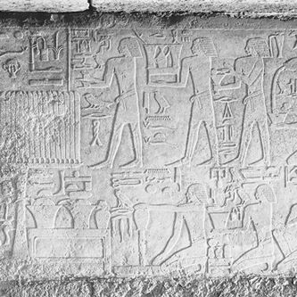 Plate IX. a. Qar, Court C, west wall, relief block in situ